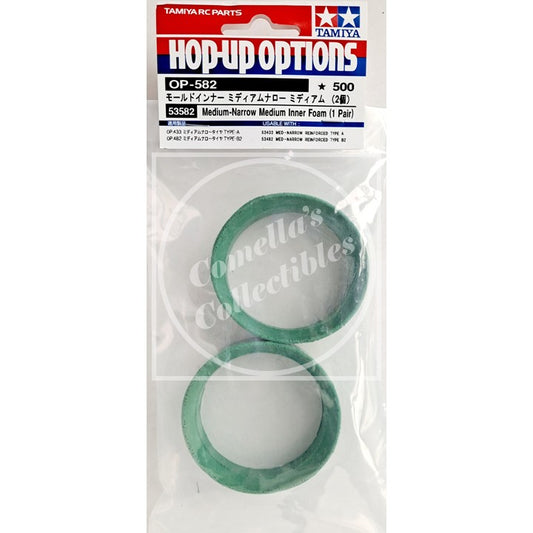 Packaged Tamiya RC parts with green and white components on a white background