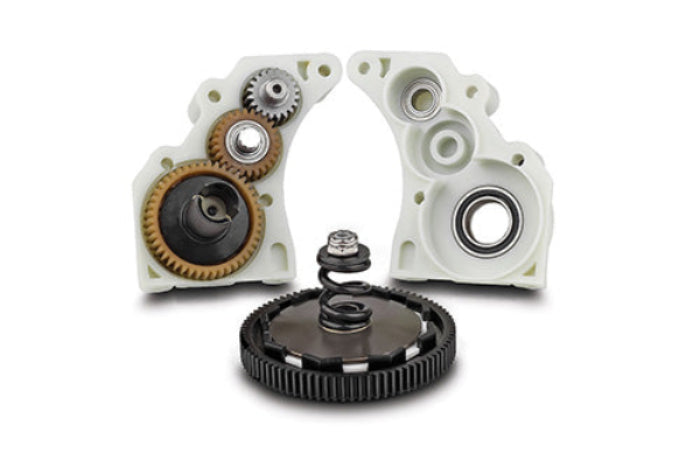 Mechanical components including gears and bearings on a white background