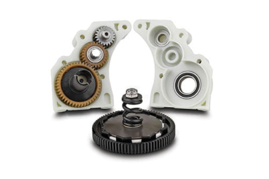 Mechanical components including gears and bearings on a white background