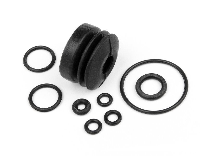 Set of black rubber components including a bellow-seal and multiple o-rings on a white background