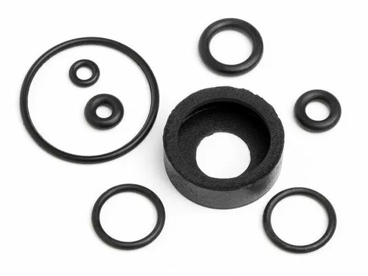 A set of black O-rings of various sizes and a dust protection cover for a model engine.