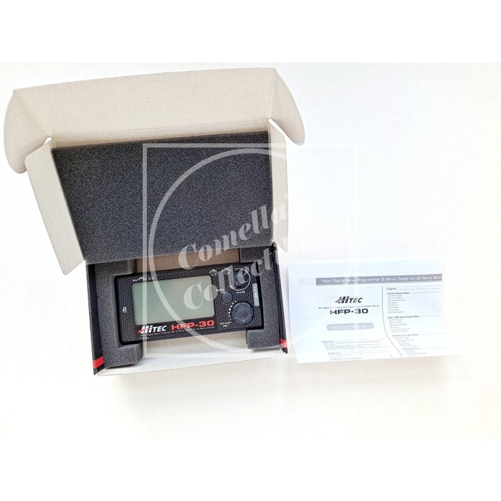Hitec servo tester and programmer with foam packaging and user manual on a white background, featuring the brand "Comella's Collectibles".