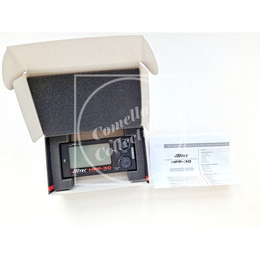 Hitec servo tester and programmer with foam packaging and user manual on a white background, featuring the brand "Comella's Collectibles".