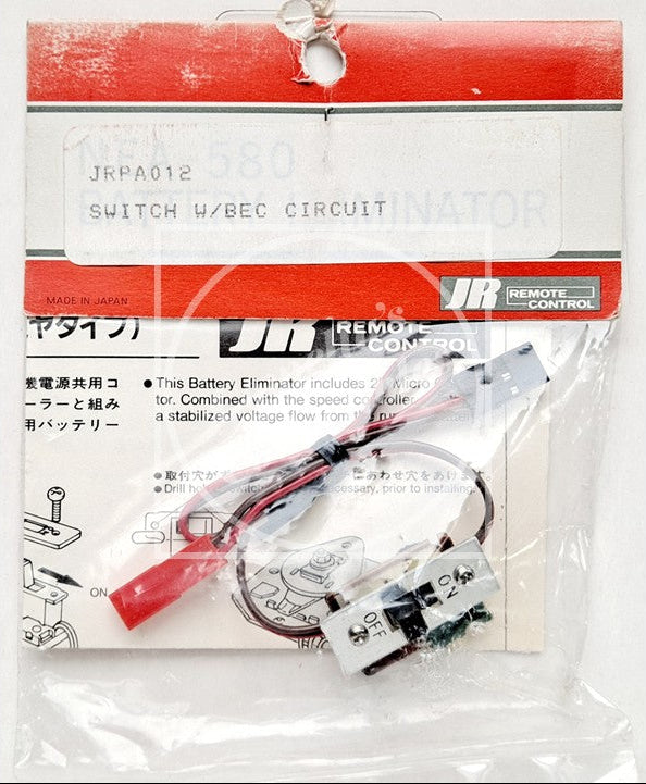 A JR Remote Control battery eliminator switch and BEC circuit kit in its original retail packaging. The kit contains a small electronic circuit board, a red and black wire, and an inline switch, all sealed inside a clear plastic bag with a red and white header card.