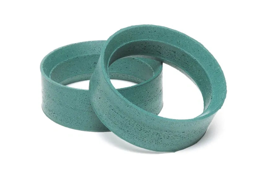 Two green Tamiya hop-up medium-narrow medium inner foam tire inserts for remote control vehicles.
