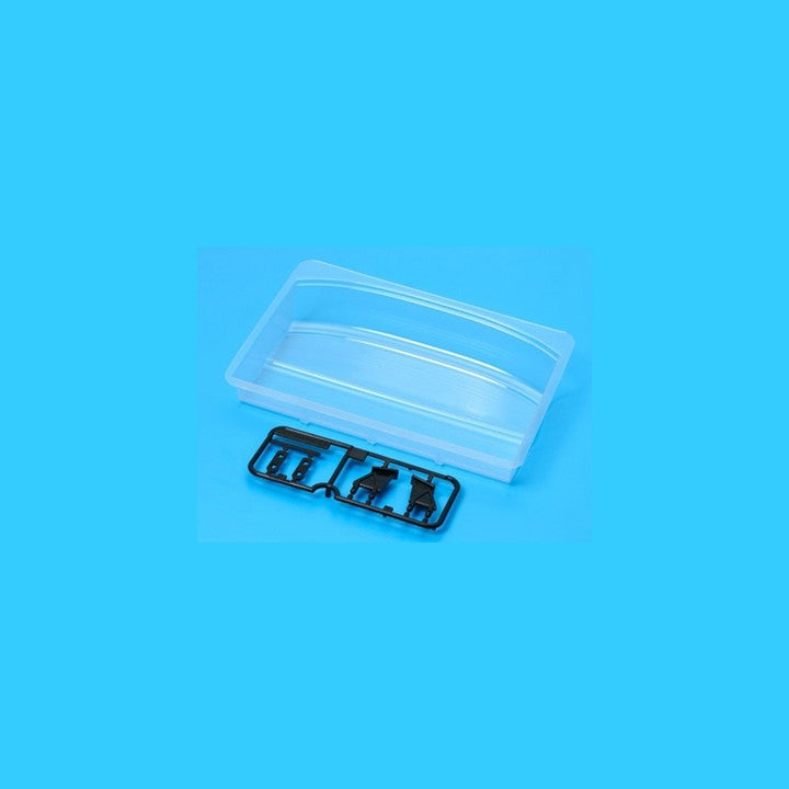 Clear plastic container with black components on a blue background