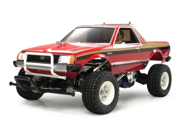 Tamiya 1/10 scale Subaru Brat 2WD RC car kit with a red and black body, displayed unassembled.