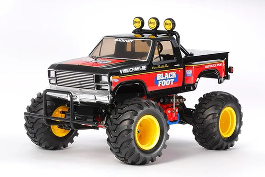 Tamiya RC 1/10 Blackfoot 2016 2WD assembly kit with decals, showing the completed model with large off-road tires, yellow wheels, and a red ABS body.