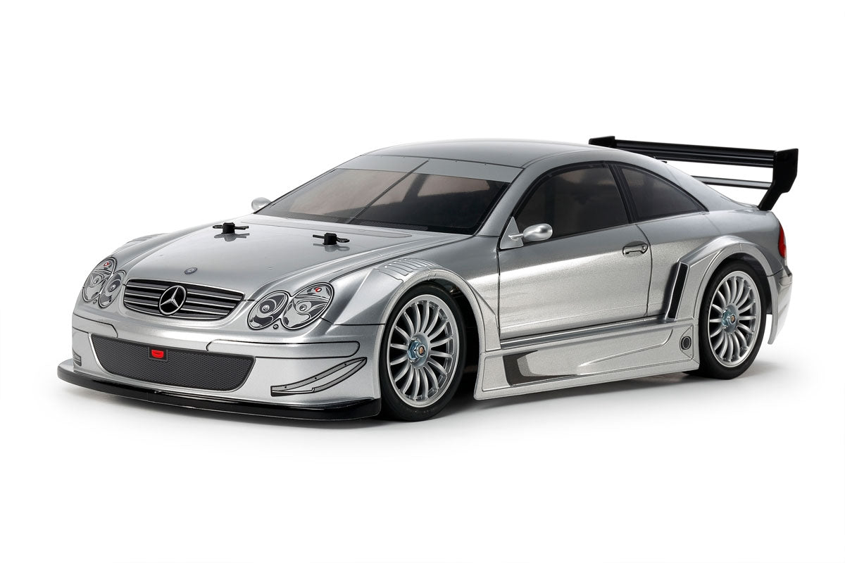 Silver model car with a large rear wing on a white background