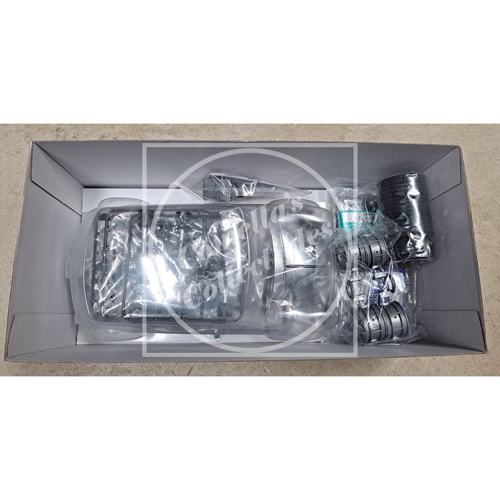 Car headlight assembly in a box on a white background
