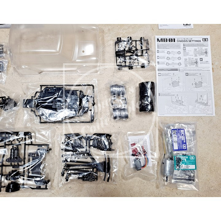 Robotics parts and components laid out on a flat surface with instructions.