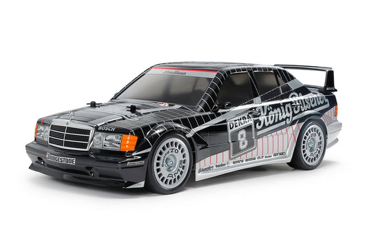 Tamiya model car with racing decals on a white background