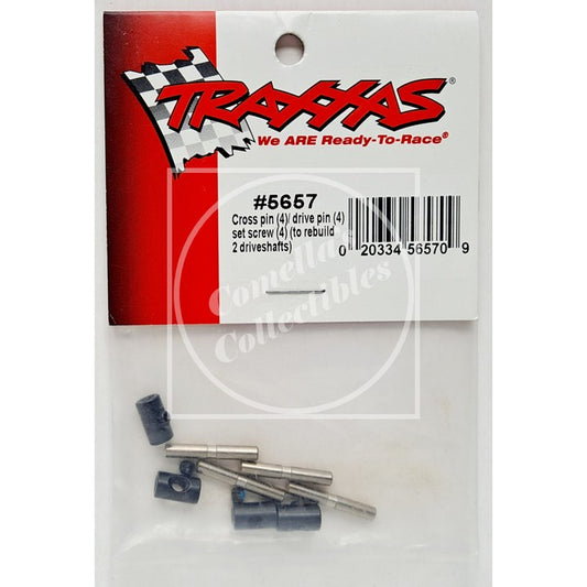 Traxxas #5657 cross pin set in a clear plastic bag with a red and white branded header card. The set includes four dark blue-gray plastic collars and four silver metal pins.