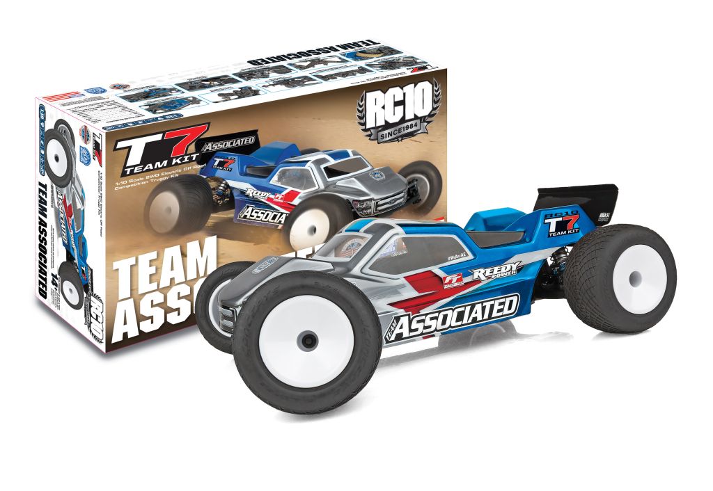 RC model car with 'Team Associated' branding next to its packaging on a white background