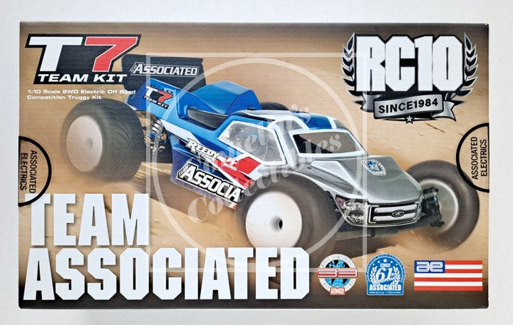 Boxed Team Associated RC10 model kit with a toy car on a white background