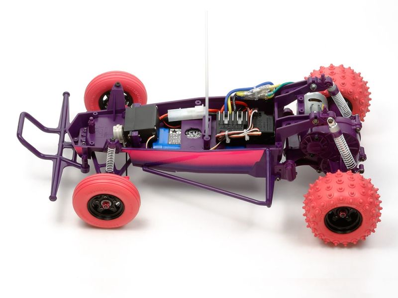 Close-up of a purple and pink toy car chassis with visible wiring on a white background