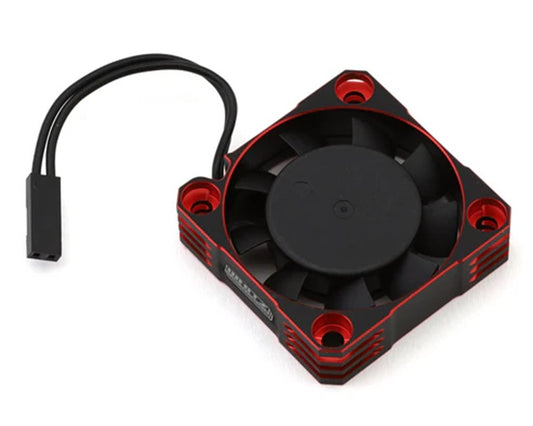 Small black and red fan with a cable on a white background
